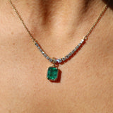 Necklace with a green gemstone pendant on a person's neck