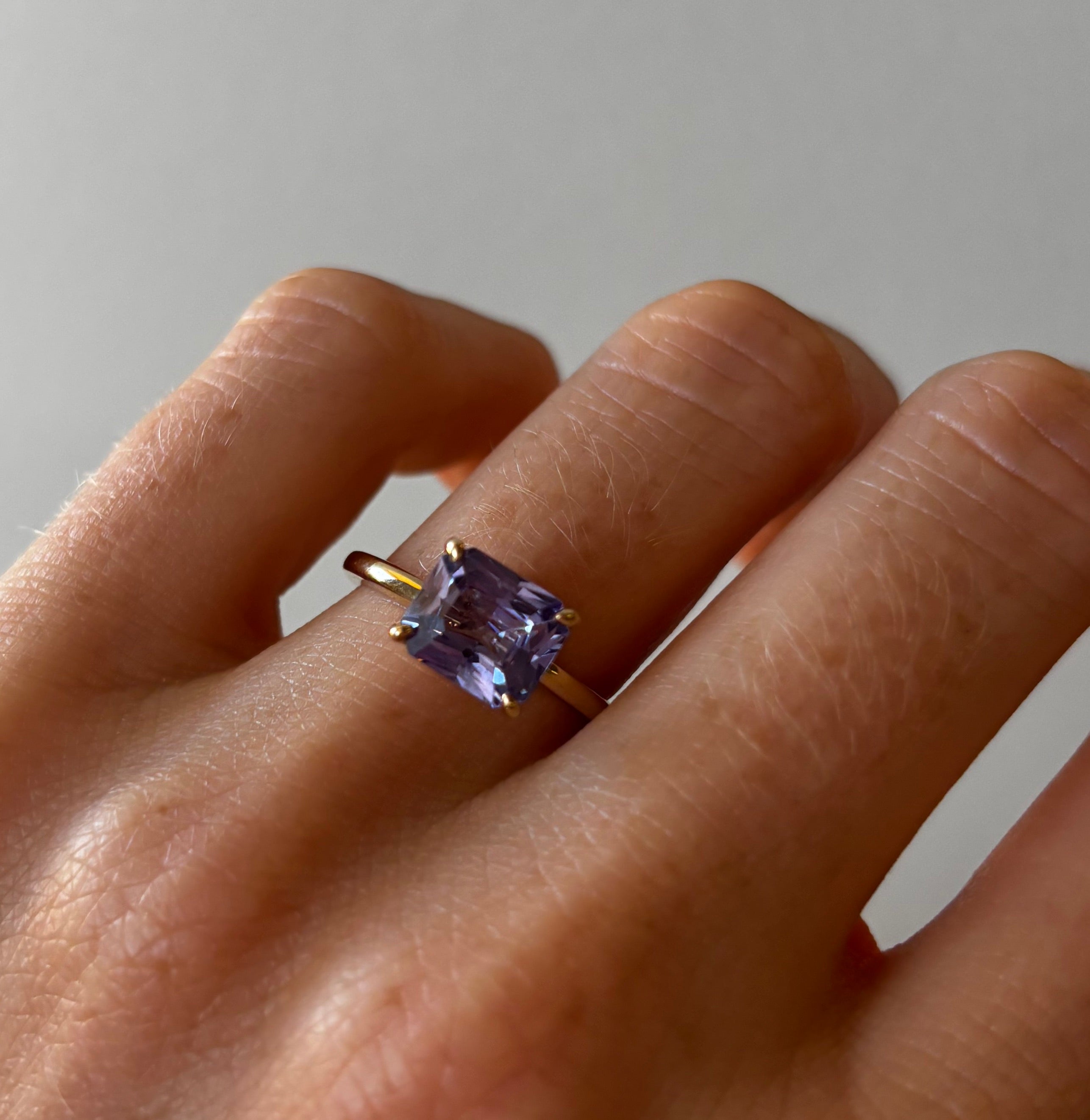 Purple Sapphire East-West ring on hand