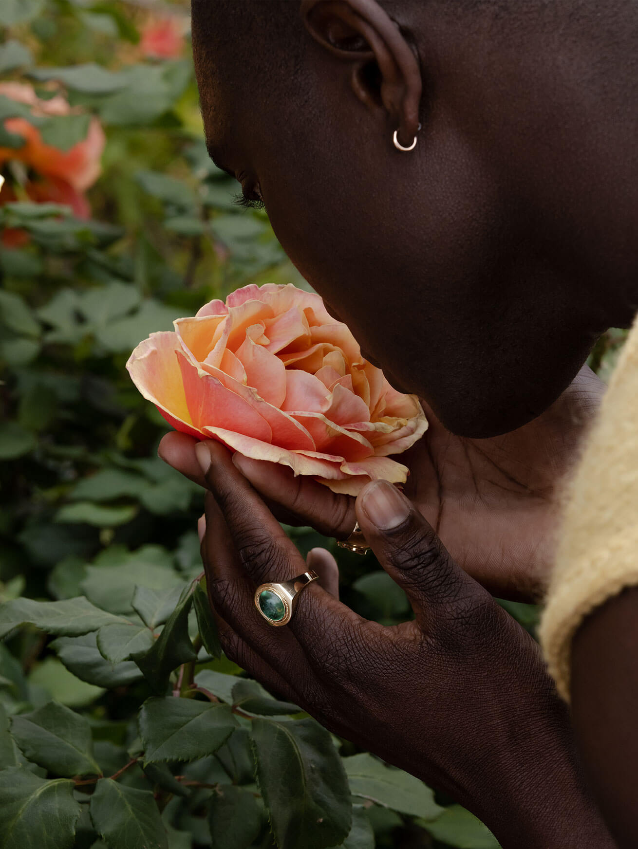 man smelling flower with Marrow Fine jewelry