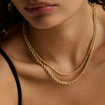 two layered yellow gold chains on woman's décolletage 