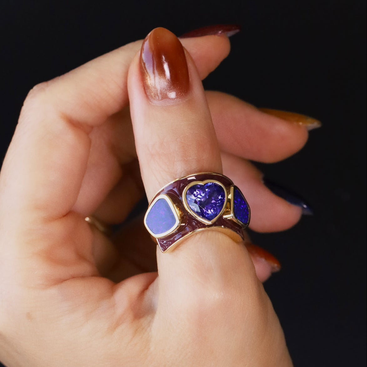 One-of-a-kind 3.26ct tanzanite heart ring flanked by boulder opals on a berry enamel band