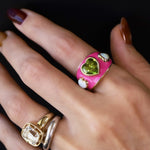 One-of-a-kind 3.81ct peridot heart ring flanked by two opal hearts on a hot pink enamel band