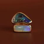 Opal ring with gold setting on a brown background