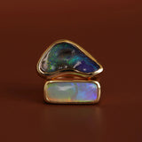 Opal ring with gold setting on a brown background