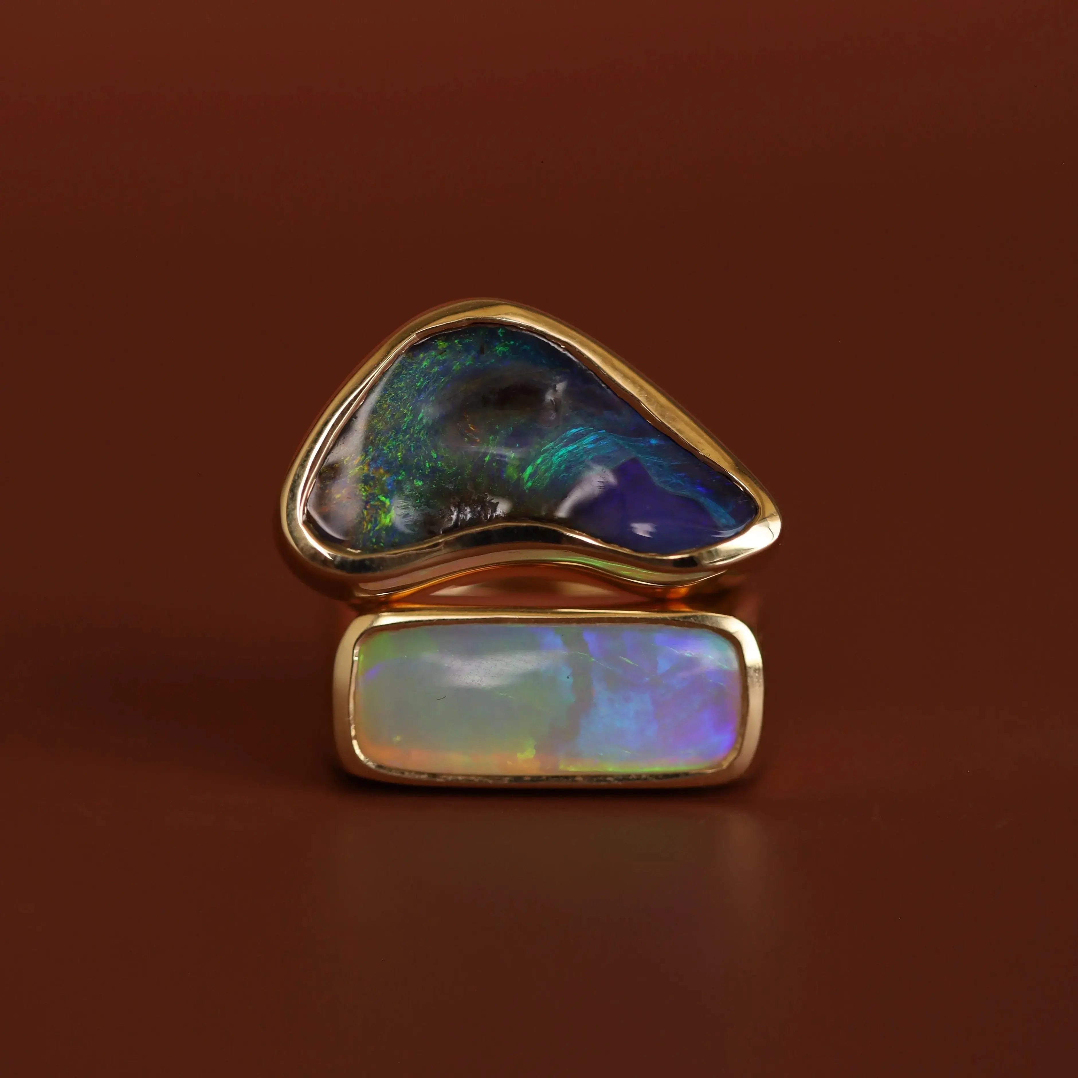 Opal ring with gold setting on a brown background