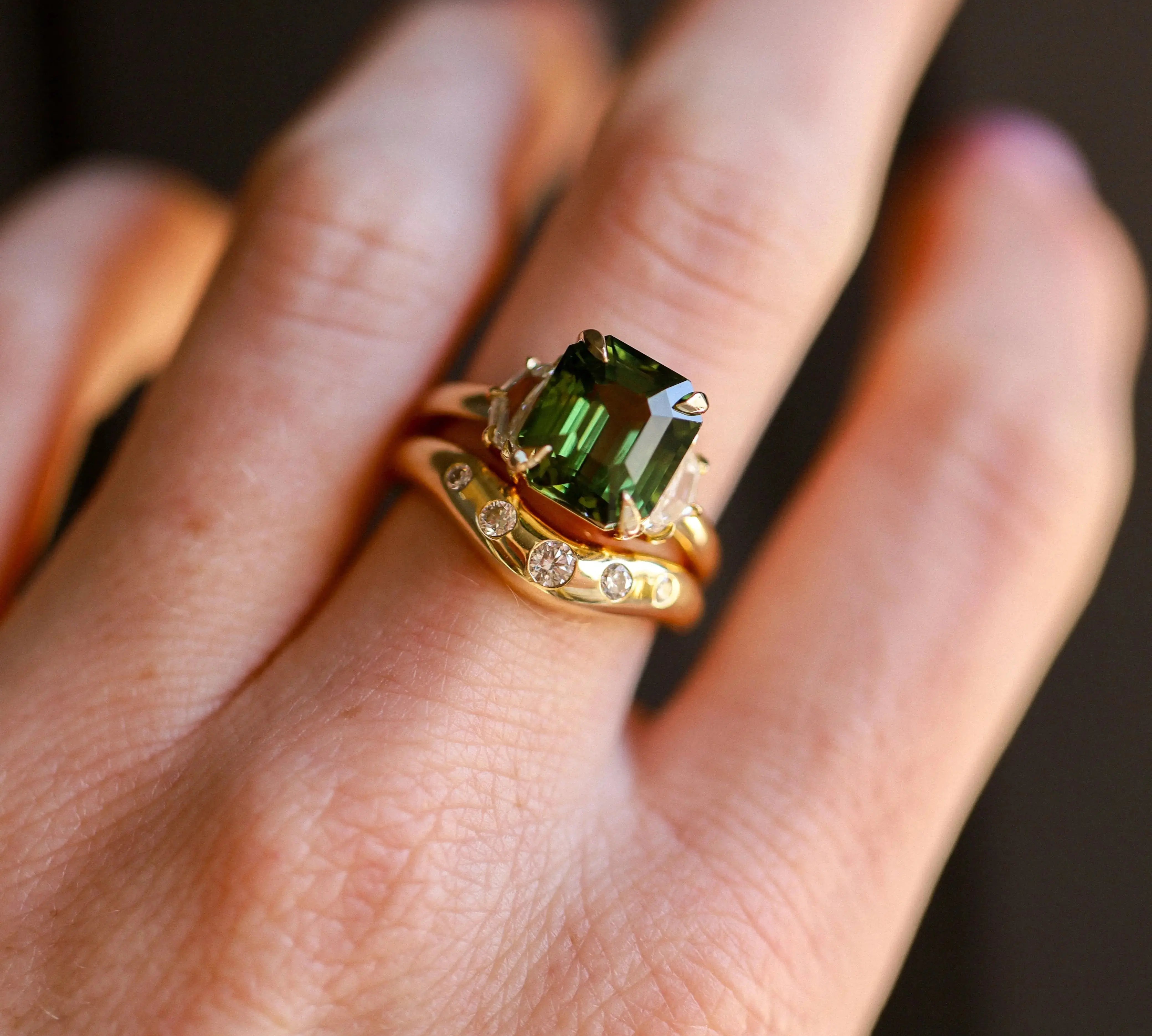 6.12ct Green Sapphire and 0.66tcw Cadillac Diamond Three Stone Ring on hand