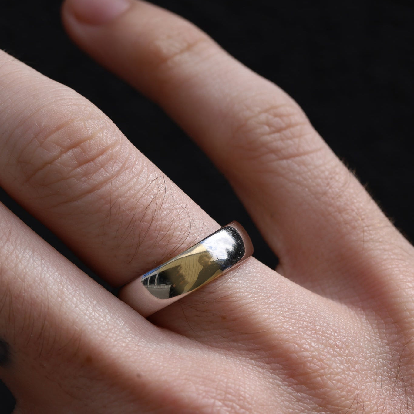 Close-up of two-tone men's band on hand