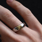 Close-up of two-tone men's band on hand