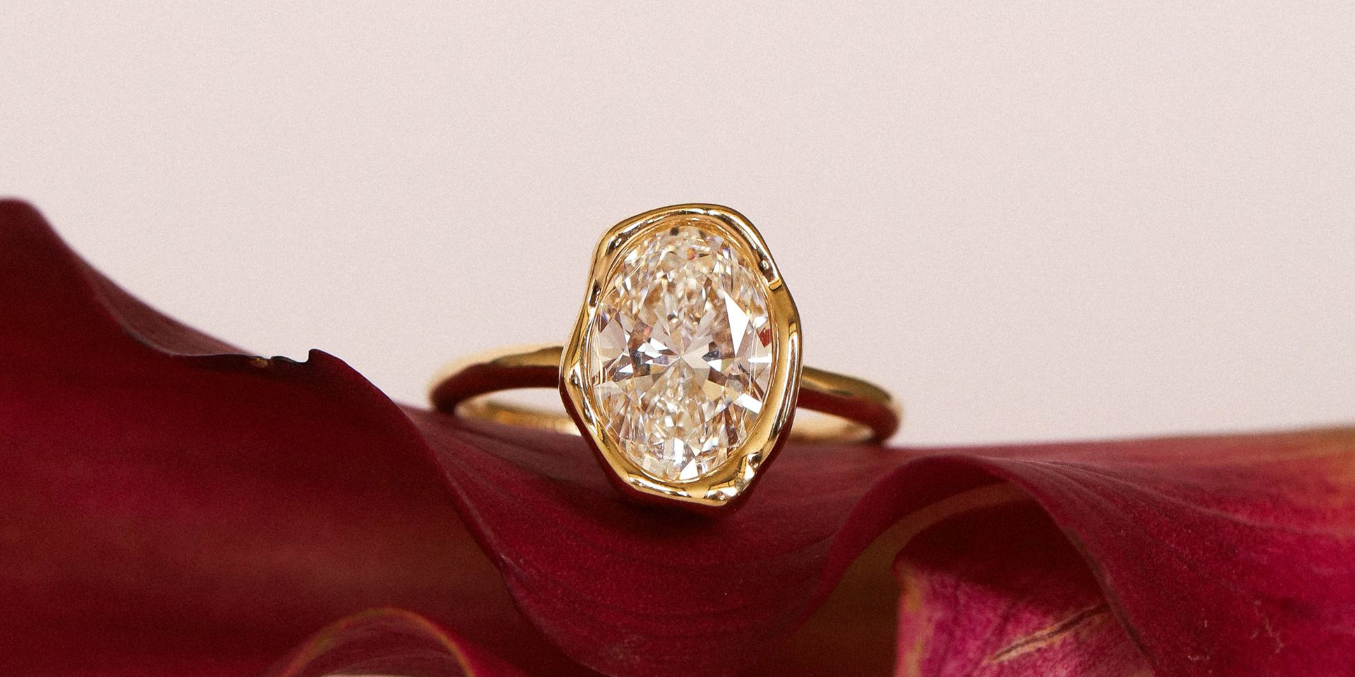 Abstract Bezel Diamond ring flat lay, on a pink flower