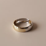 Flat lay of two-tone men's band against neutral, solid background