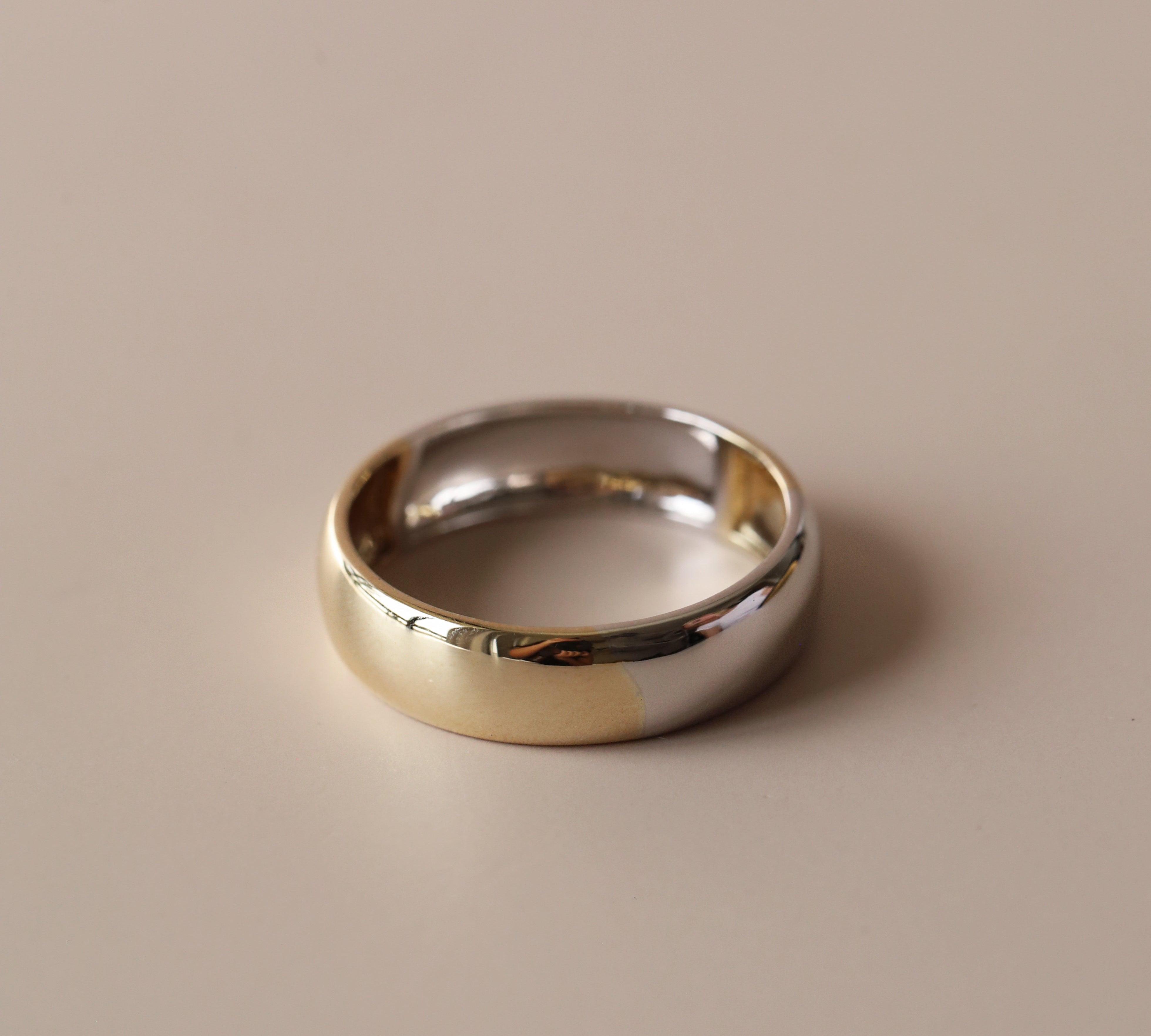 Flat lay of two-tone men's band against neutral, solid background