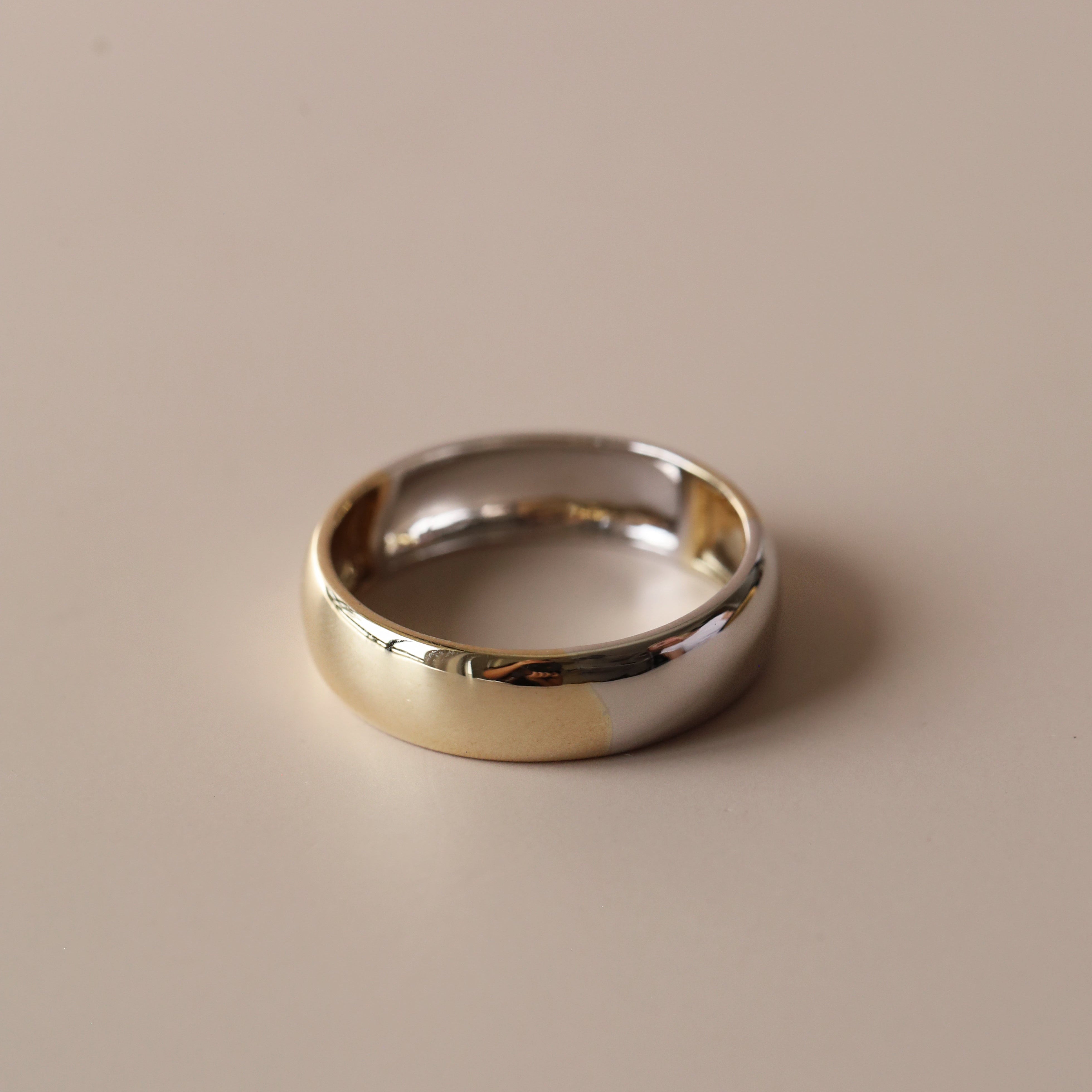 Flat lay of two-tone men's band against neutral, solid background