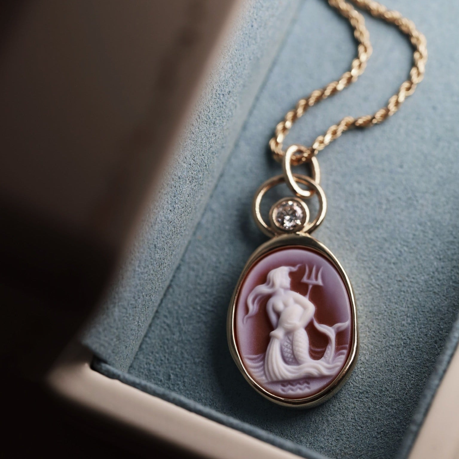 Aquarius Zodiac orange agate carving pendant in 14k yellow gold with a floating diamond