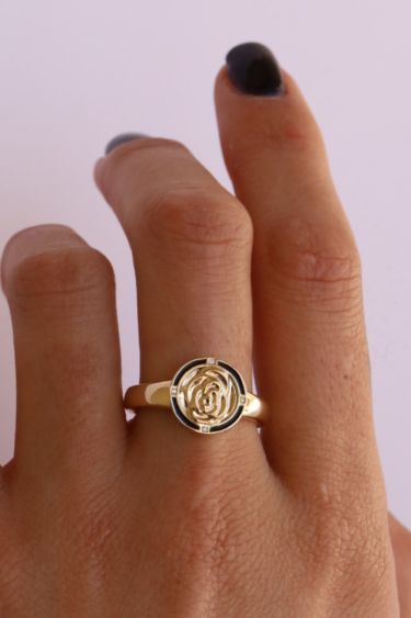 Close up of hand with Marrow enamel rose signet ring