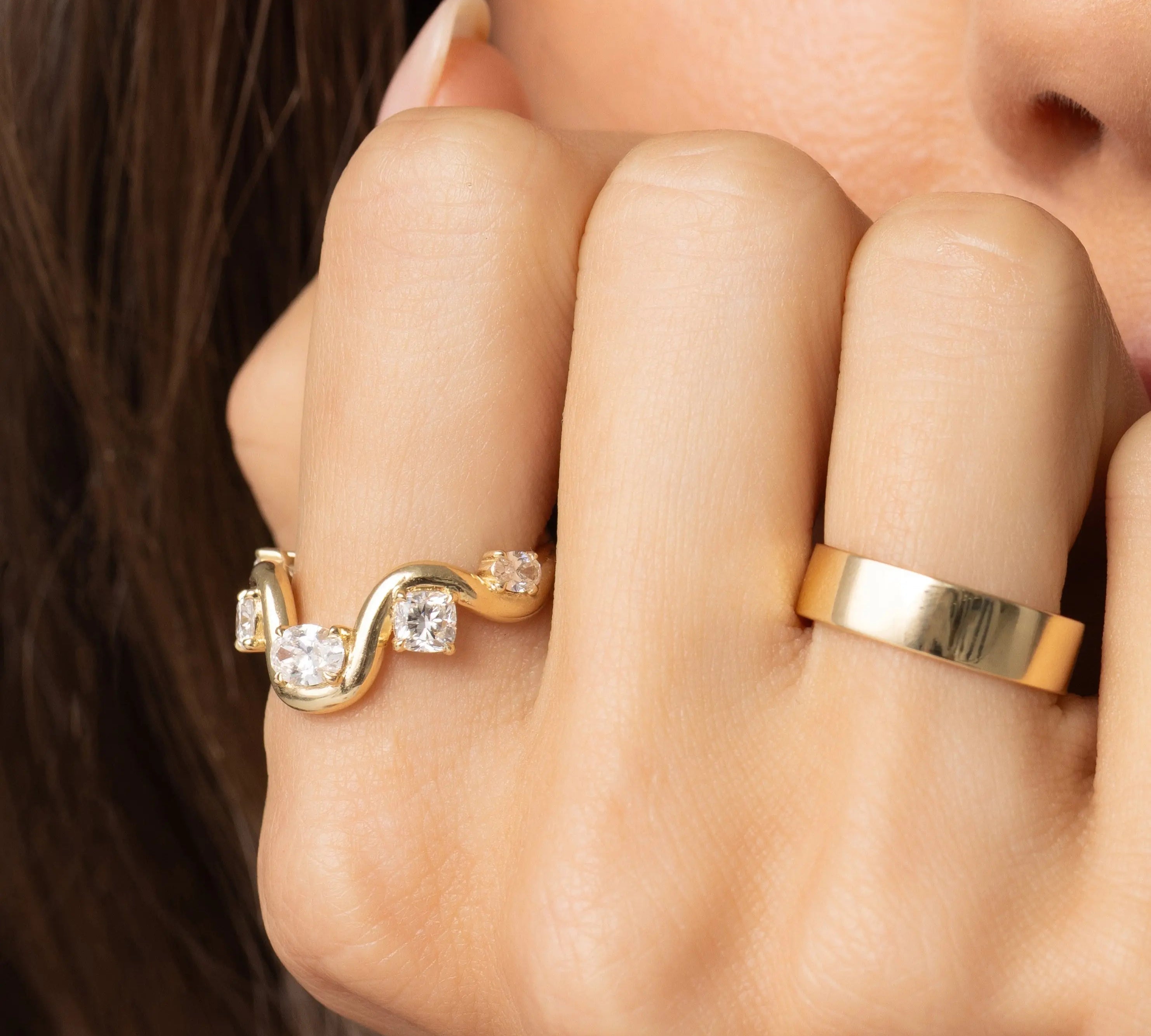 Close up of model with hand resting on her face, featuring Arno Serpentine Band
