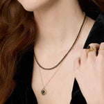 Close up of Black Diamond Tennis Necklace and Black Diamond La Femme Pendant on woman's décolletage 