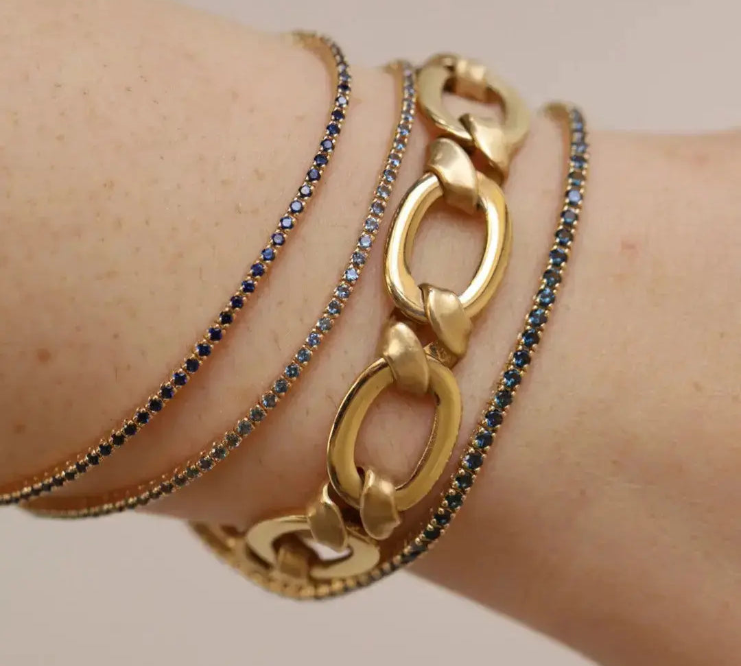 Close up of wrist featuring 1.56tcw Indigo Sapphire Tennis Bracelet, 1.58tcw Dark Blue Sapphire Tennis Bracelet and 2.93tcw Dark Blue Sapphire Tennis Bracelet