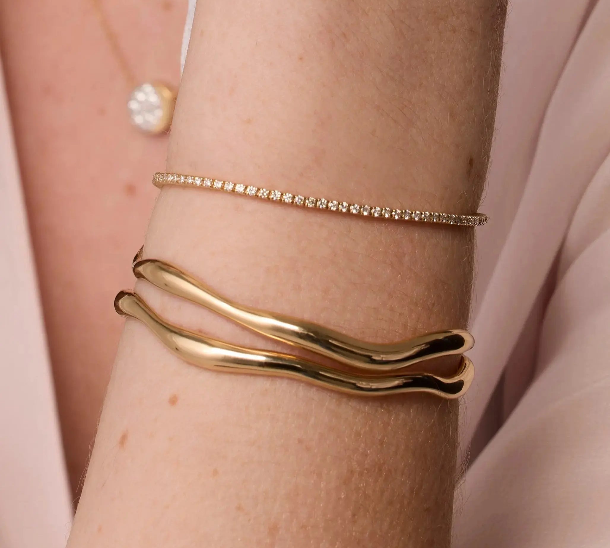 Coco Tennis Bracelet & Curved Freeform Gold Cuff close up of woman's wrist