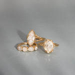 Gold rings with diamond accents on a gray background