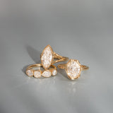Gold rings with diamond accents on a gray background