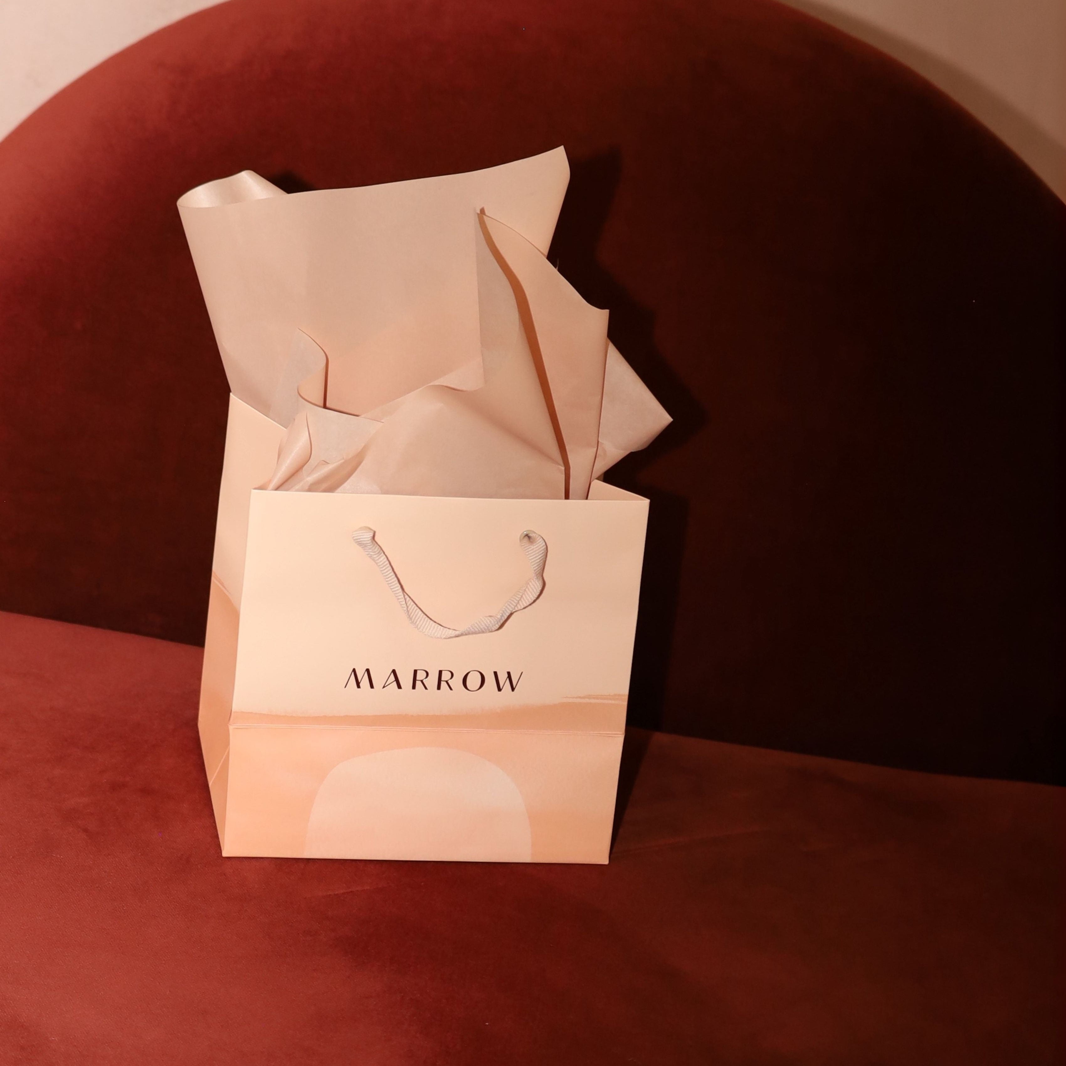 Marrow gift bag with tissues on a red surface