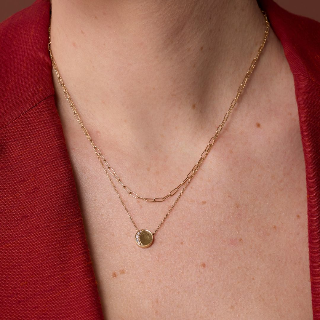 Close up of Under the Perfect Moon Pendant - Crescent Moon on woman's neckline