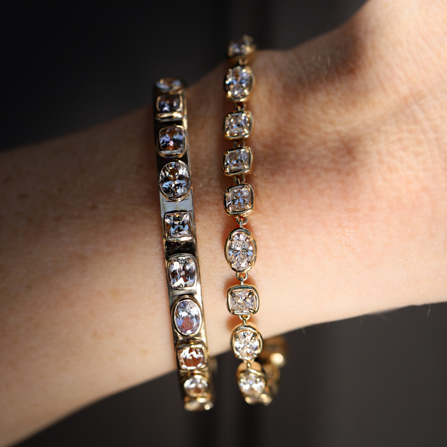 6.41tcw Fancy Tanzanite Cuff + Lisse Lab Grown Diamond Tennis Bracelet shot up close on a person's wrist.