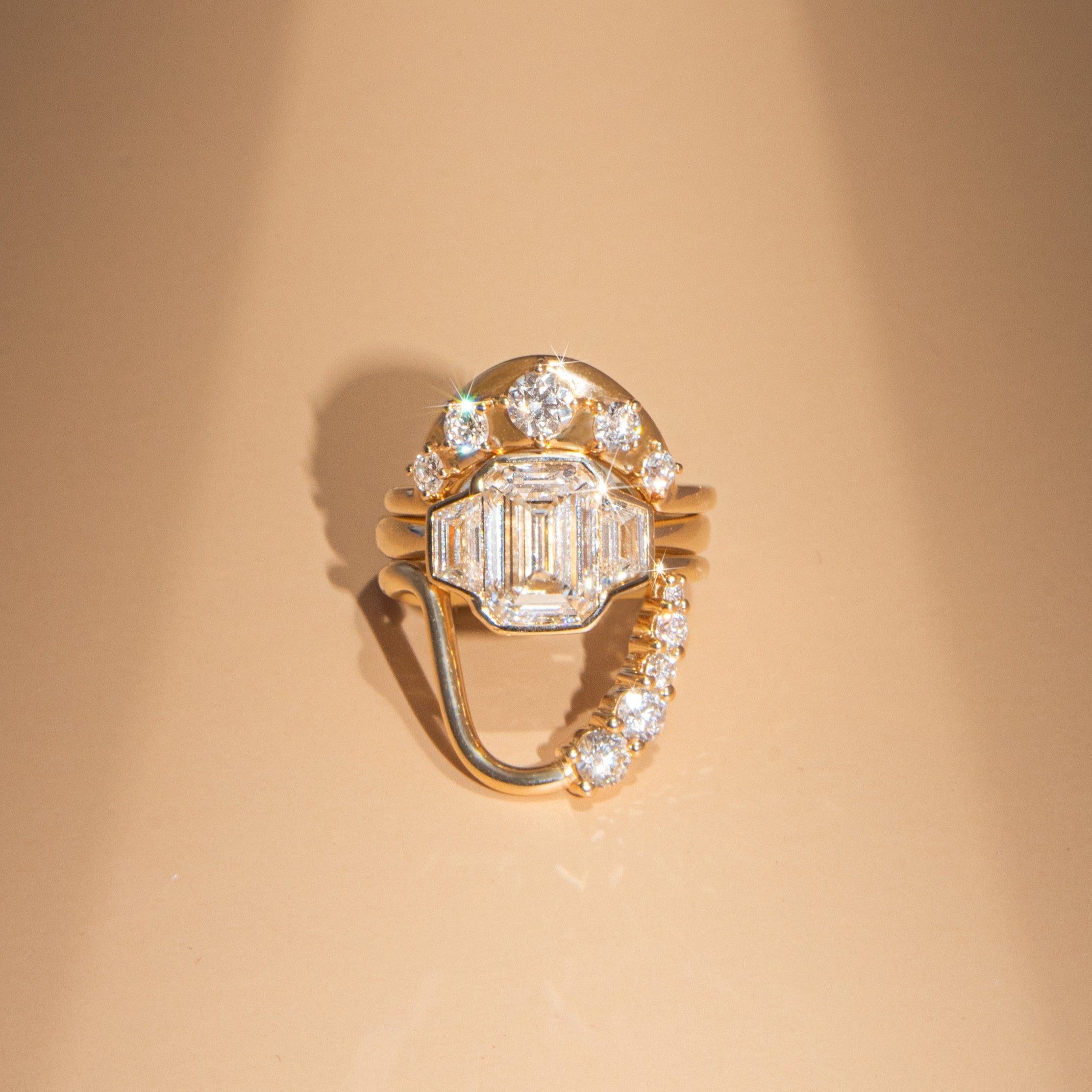 Gold ring with a diamond on a beige background