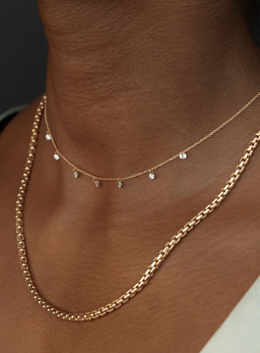 Close up of woman's neck wearing Marrow Fine Dainty Diamond Choker and solid gold chain.