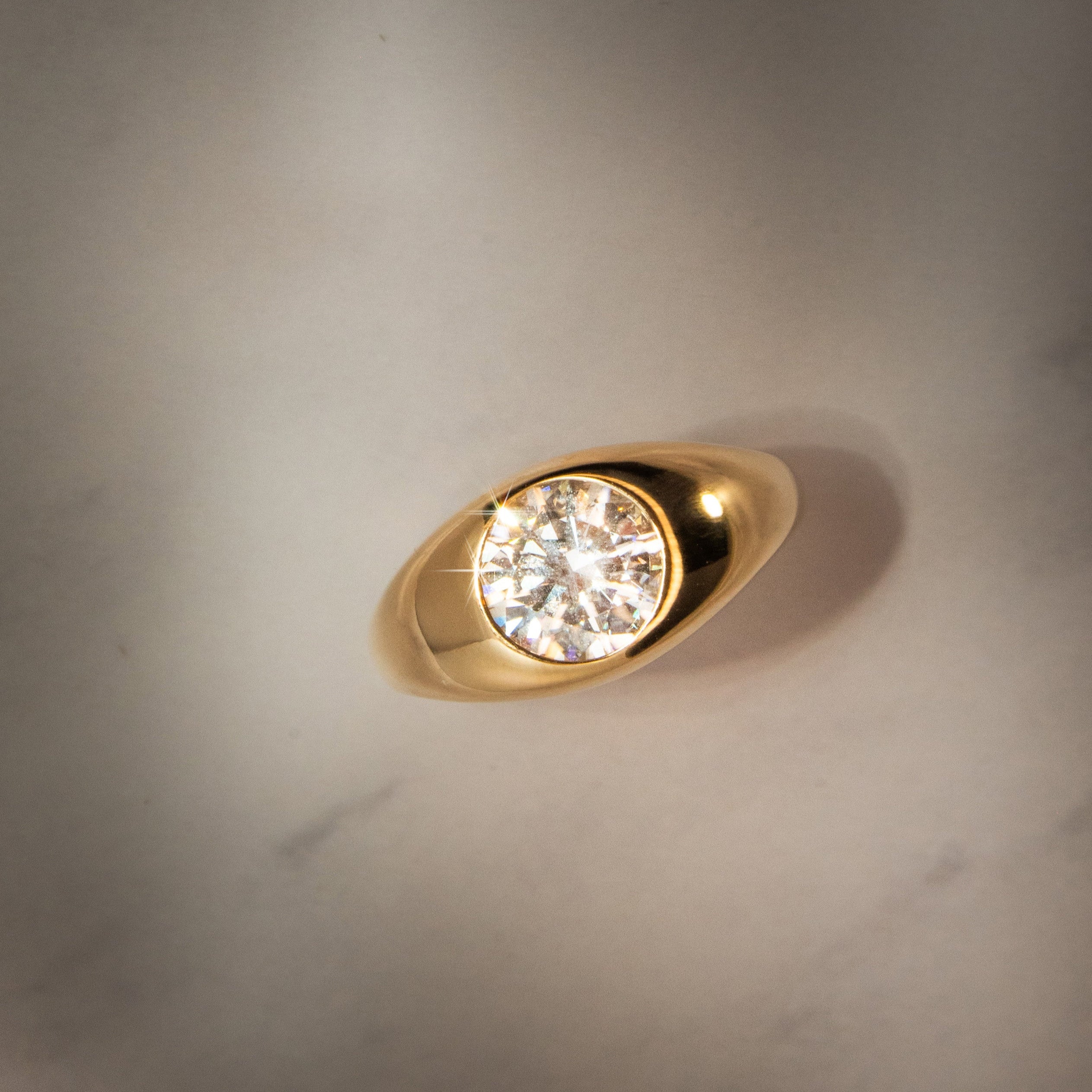 Flat lay birds eye view of Dyllan Round Engagement Ring in yellow gold