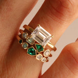 Close up of 0.13ct Emerald and Diamond Kaleidoscope Ring and 0.17ct Emerald, Opal and Diamond Kaleidoscope Ring stacked on woman's hand