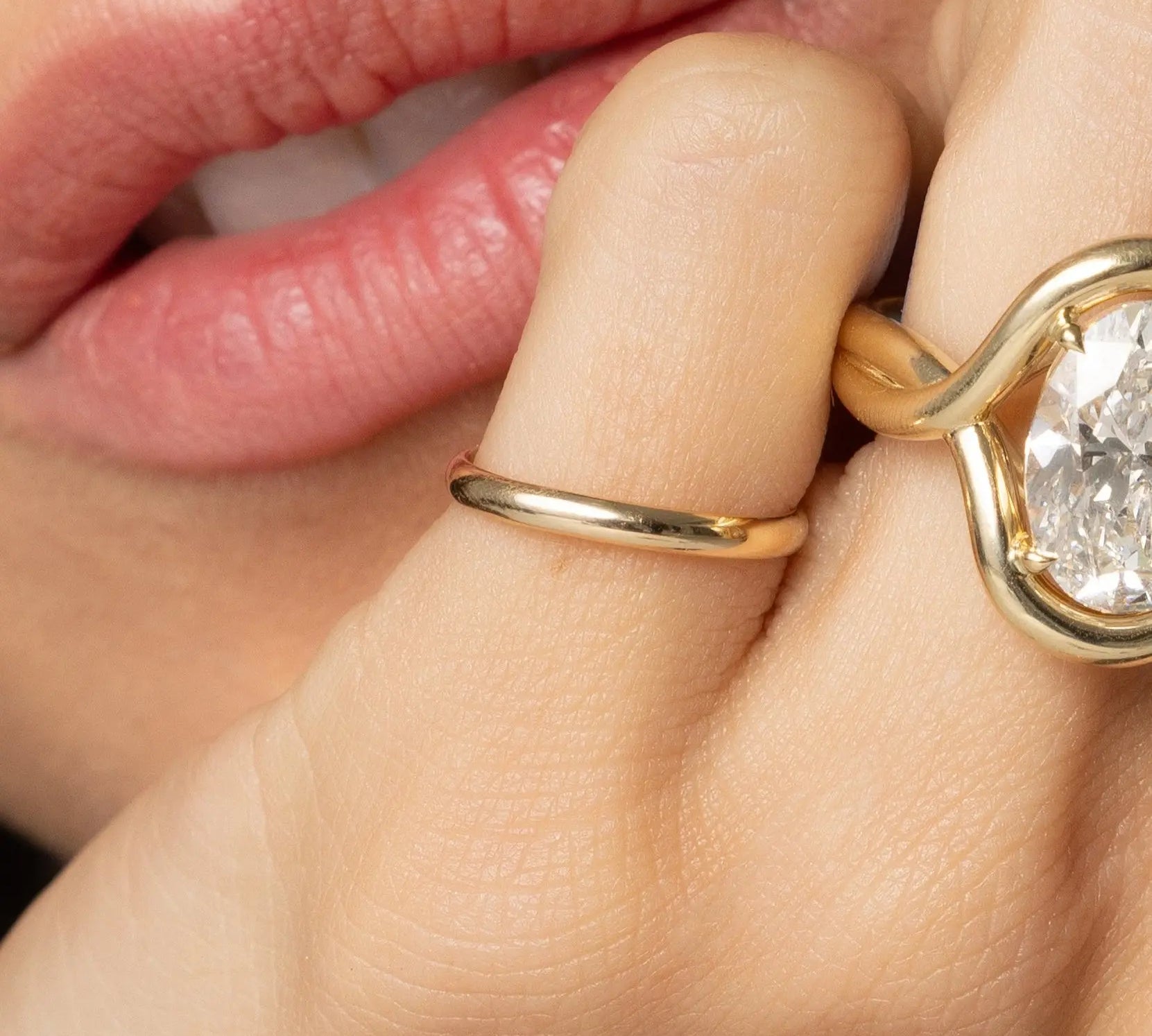 Close up of women's hand featuring multiple Marrow Fine rings styled together