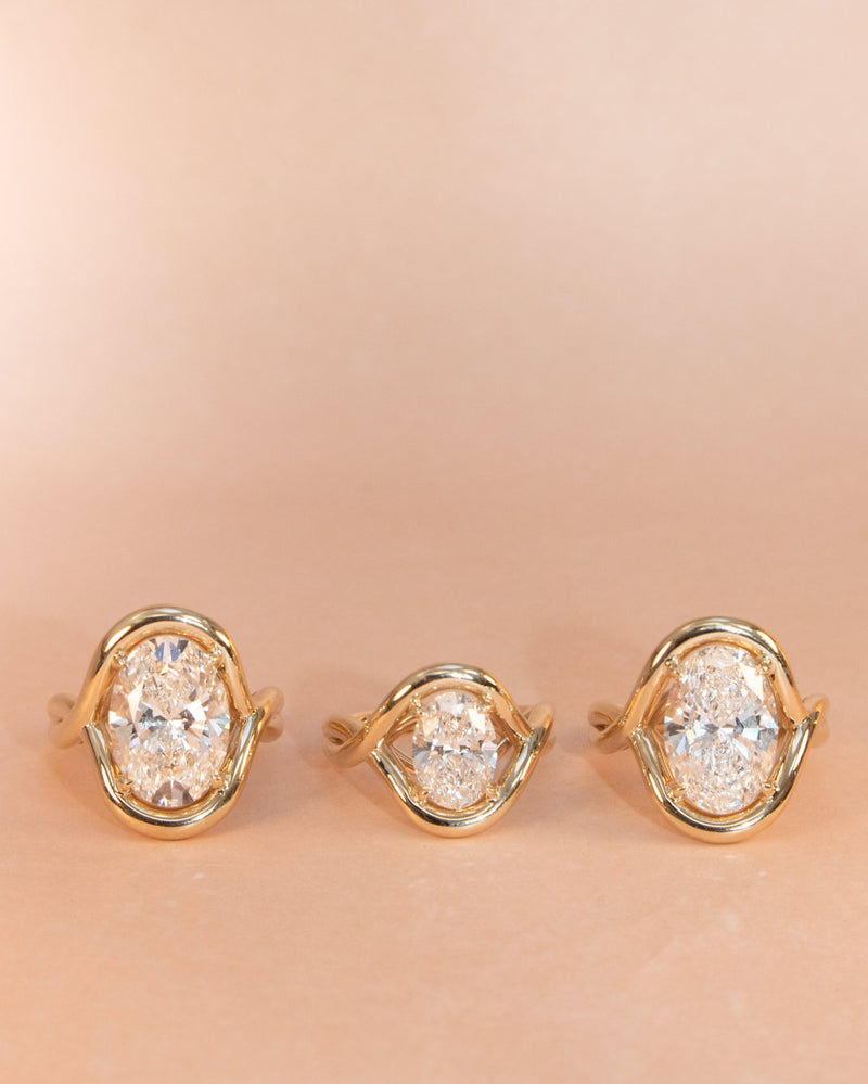 Flat lay of 3 Florence Rings featuring different carat weight diamonds