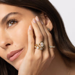 Close up of model with hand resting on her face, featuring multiple Soleil Collection rings