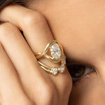 Close up of hand against woman's eye featuring the Florence Ring an Simone Arch Band