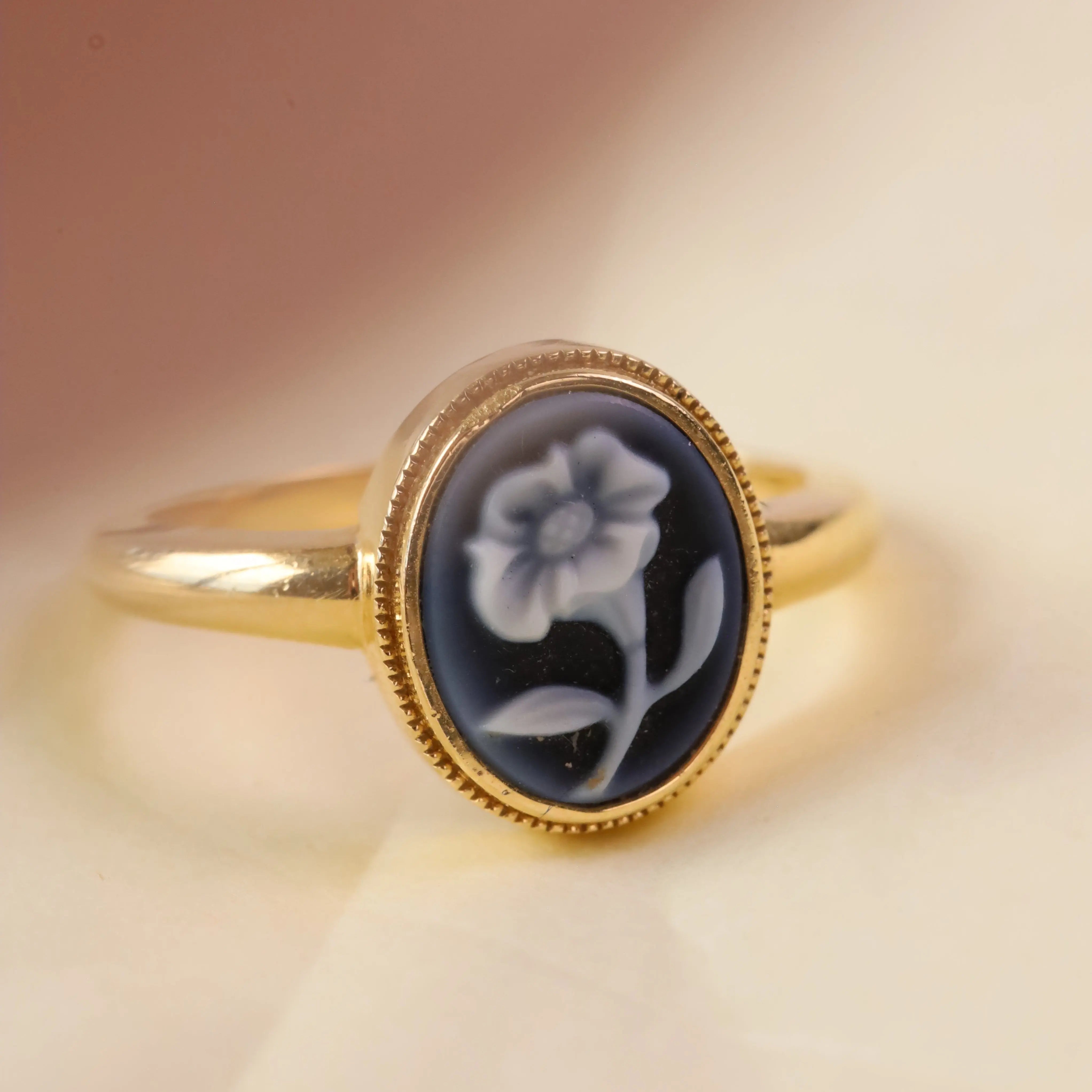 Forget Me Not Cameo Ring on a neutral beige background