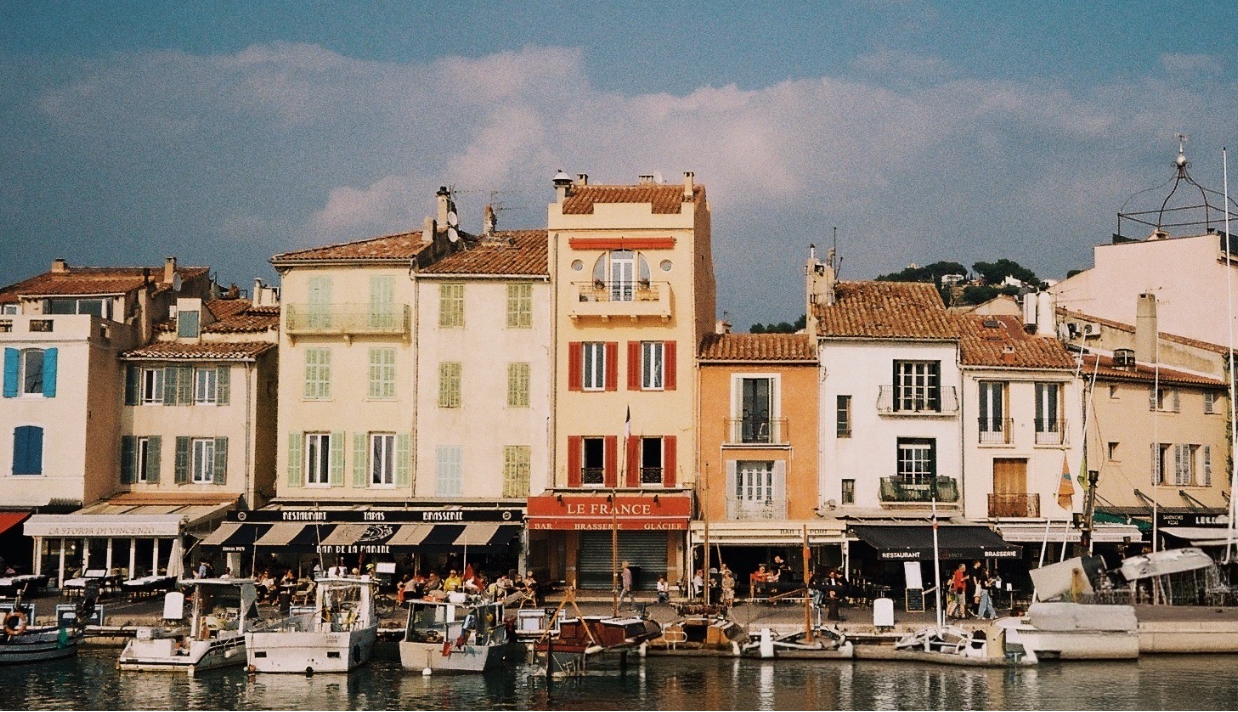 Vibrant waterfront scene with colorful buildings and boats in a coastal town.