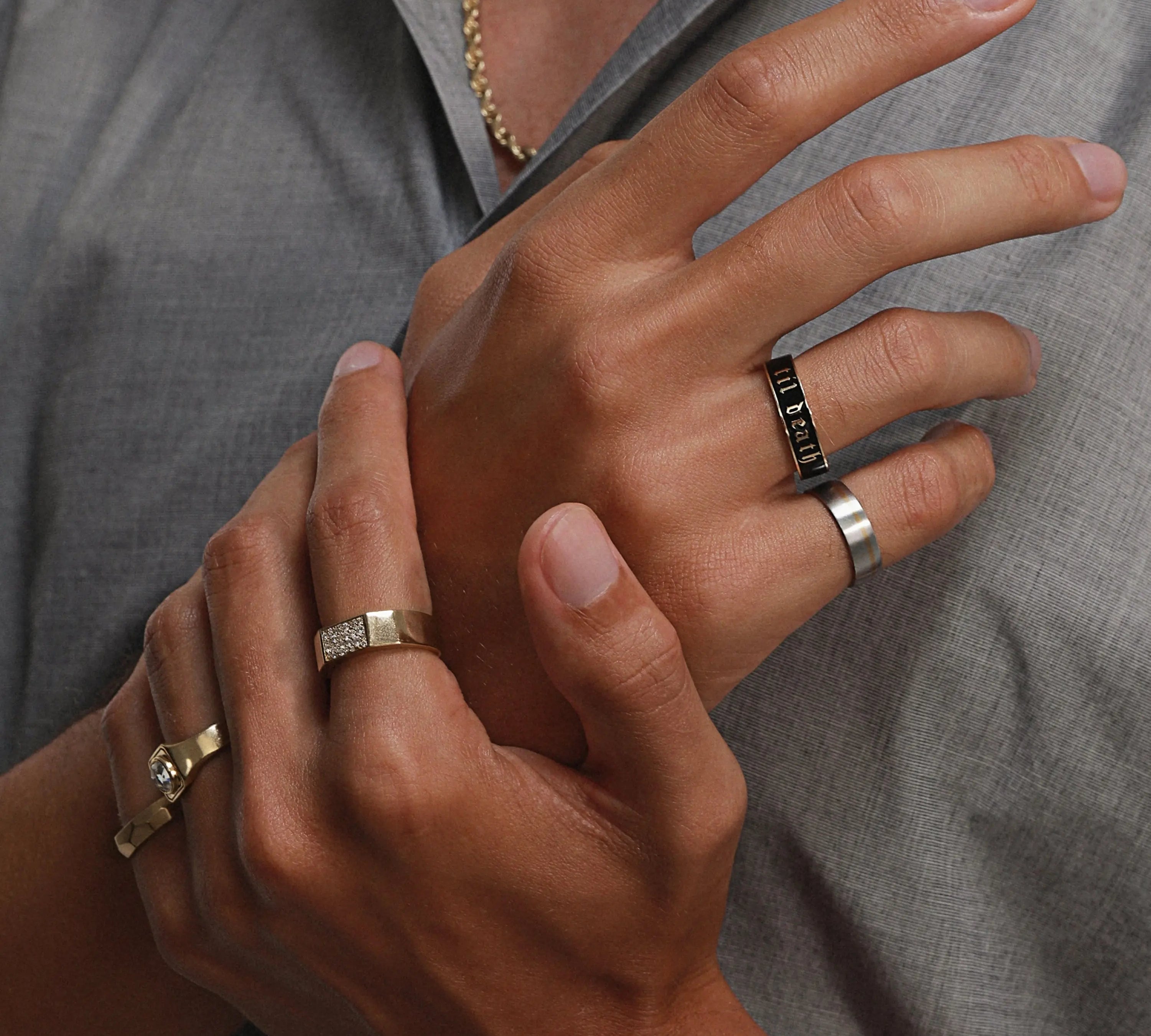 Close up of man's hands wearing multiple Marrow Fine rings