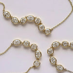 Gold necklace with diamonds on a light background
