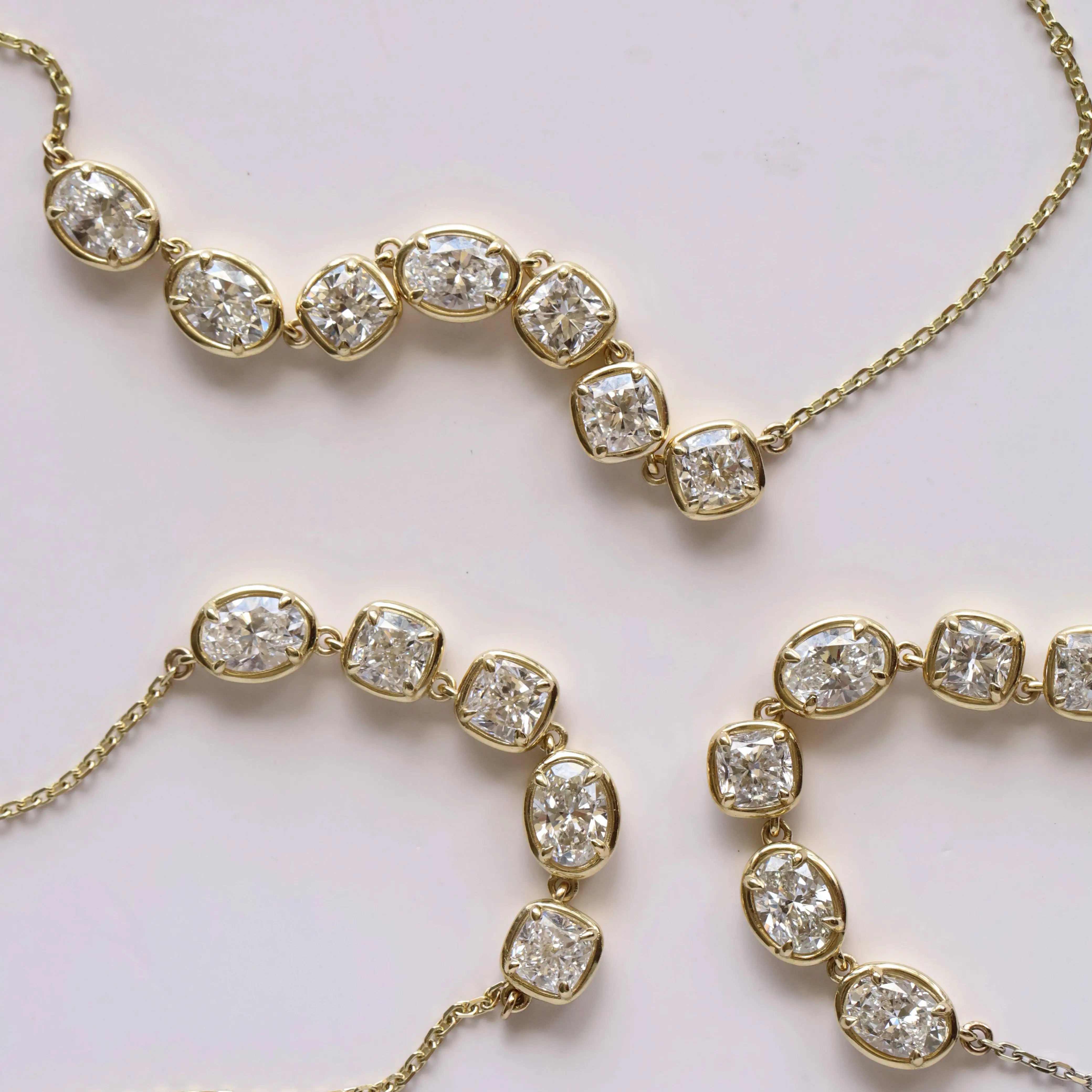 Gold necklace with diamonds on a light background