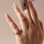 close-up of horseshoe ring on pinky
