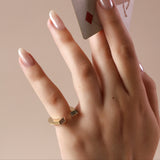 close-up of horseshoe ring on pinky