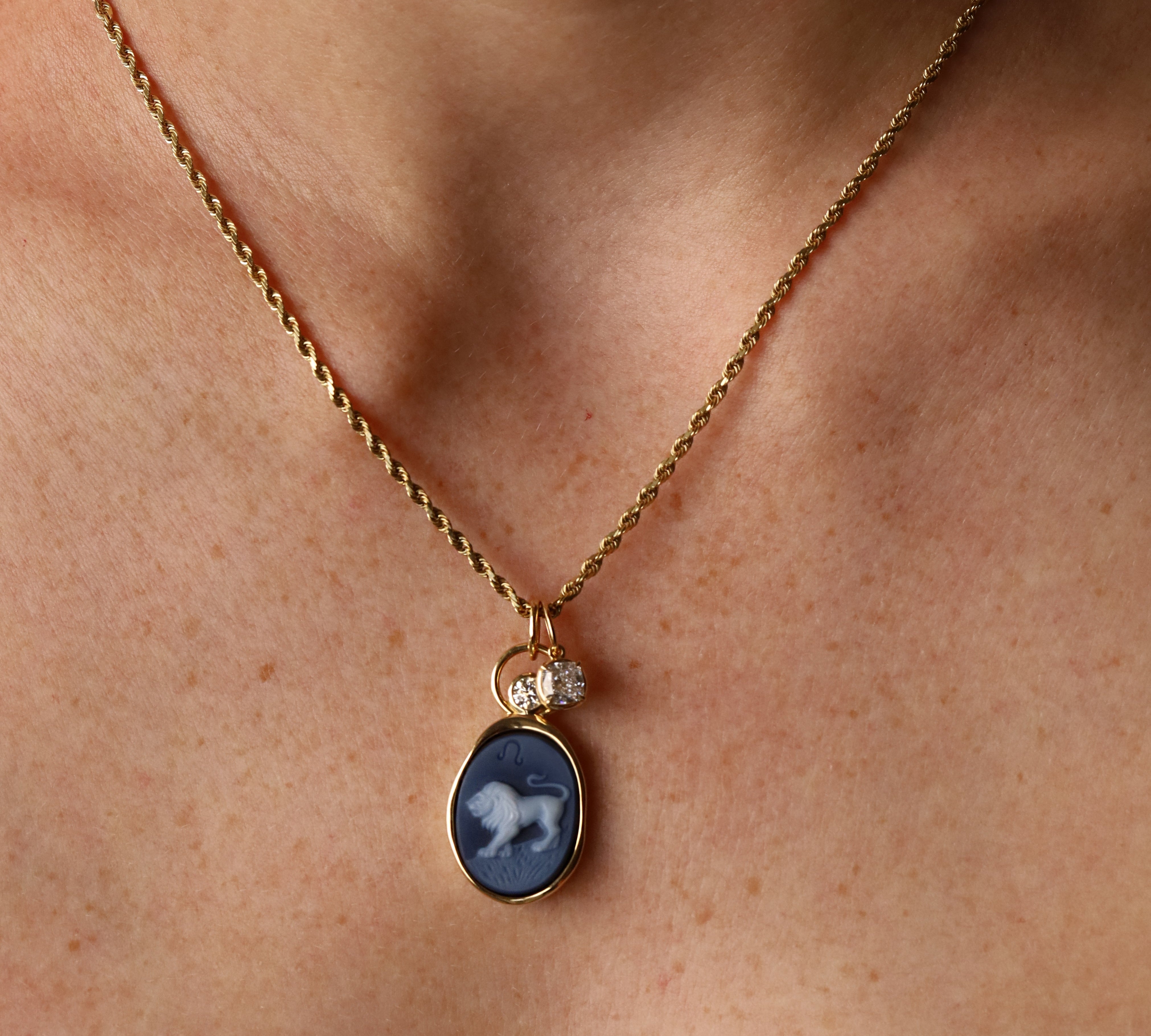 Leo Zodiac Black Agate Carving with Diamonds pendant worn on the neck, a carved black agate lion in 14k yellow gold