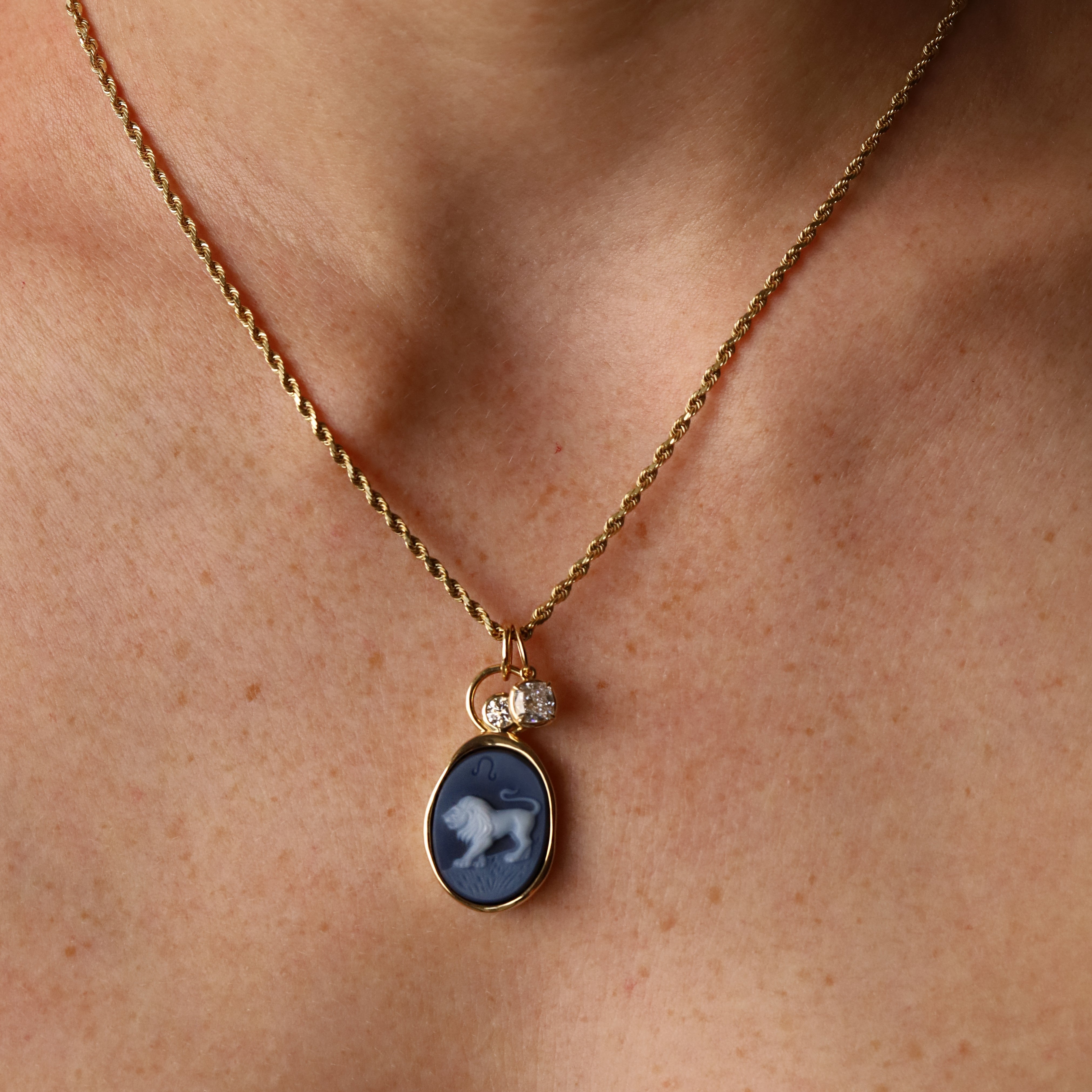 Leo Zodiac Black Agate Carving with Diamonds pendant worn on the neck, a carved black agate lion in 14k yellow gold