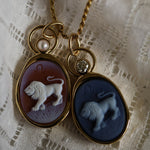 Leo Zodiac agate carving pendants in black agate with a diamond and orange agate with a pearl, side by side