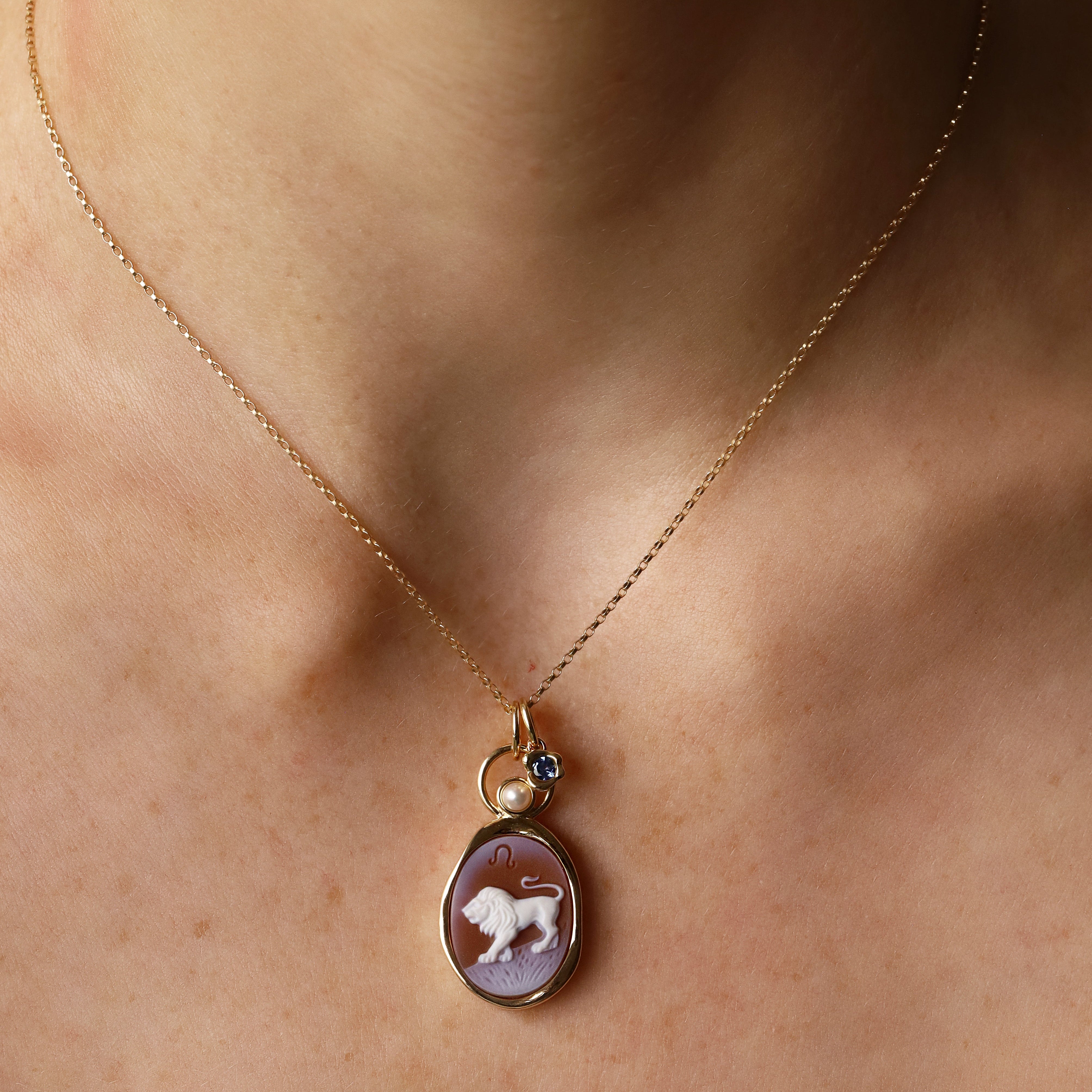 Leo Zodiac Orange Agate Carving with Pearl pendant in 14k yellow gold, a carved white lion with a floating cultured pearl