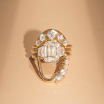Gold ring with diamonds on a beige background