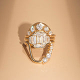 Gold ring with diamonds on a beige background