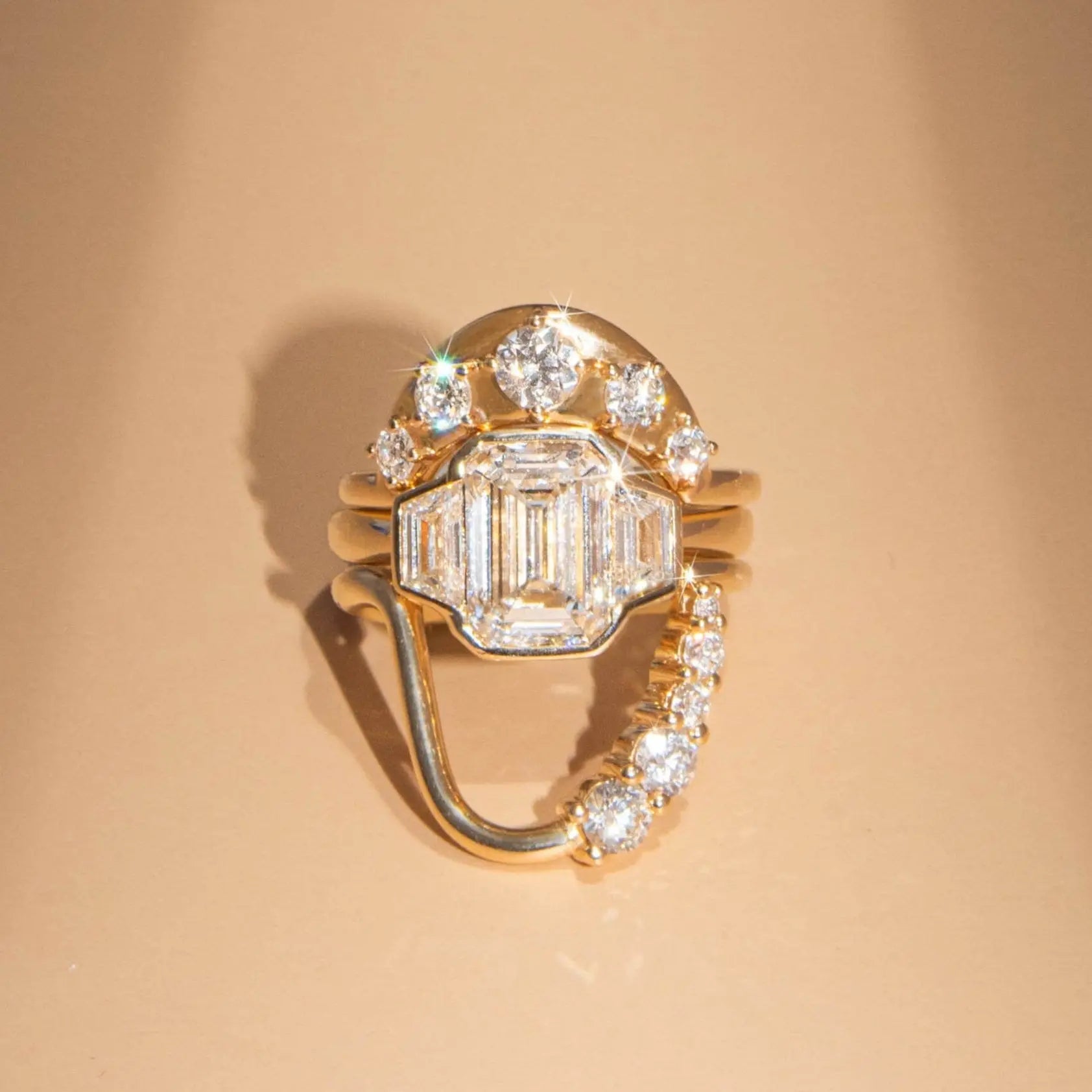 Gold ring with diamonds on a beige background