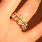 Gold ring with diamonds on a person's finger